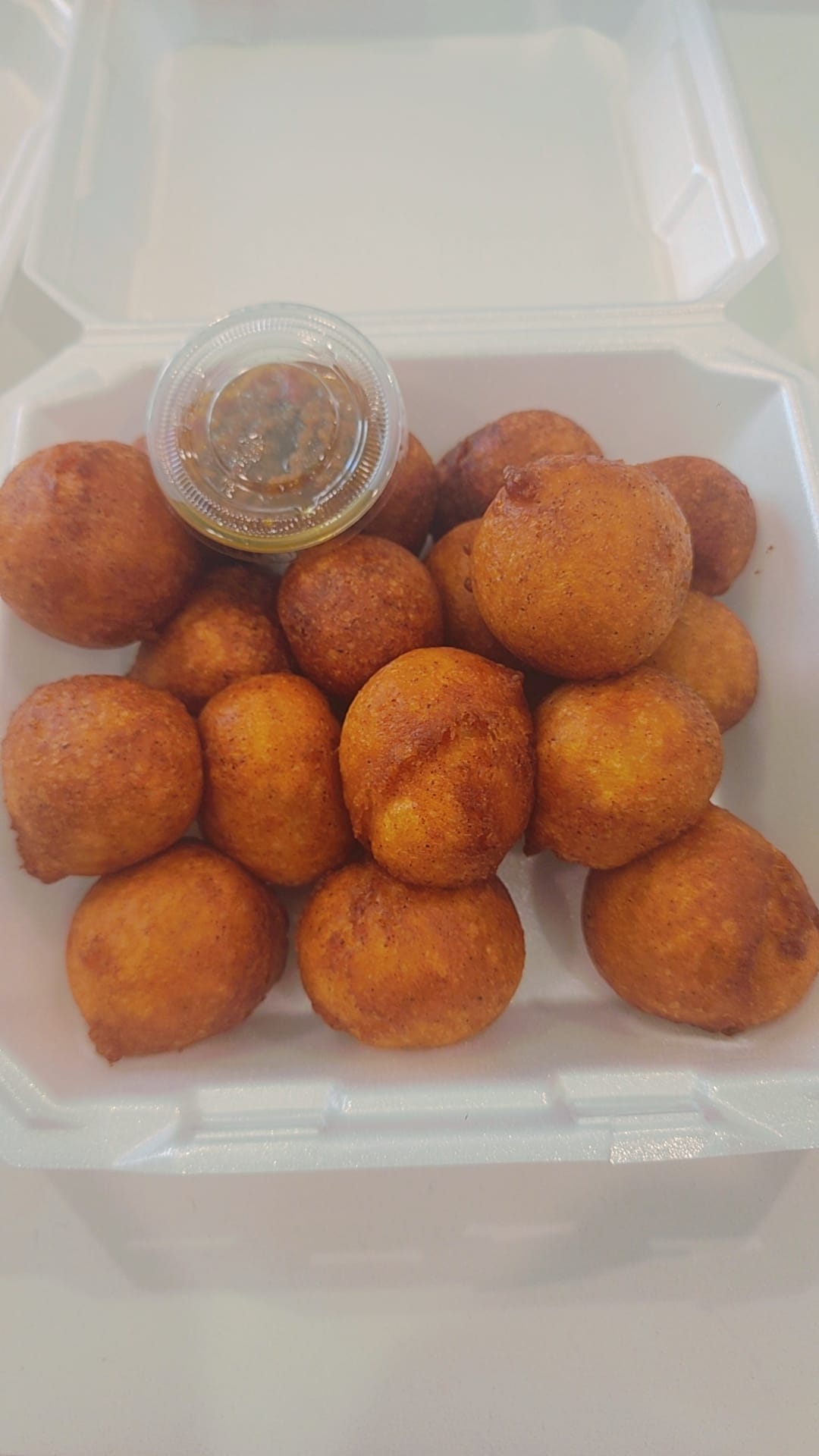 Golden fried kala dough balls with pepper sauce