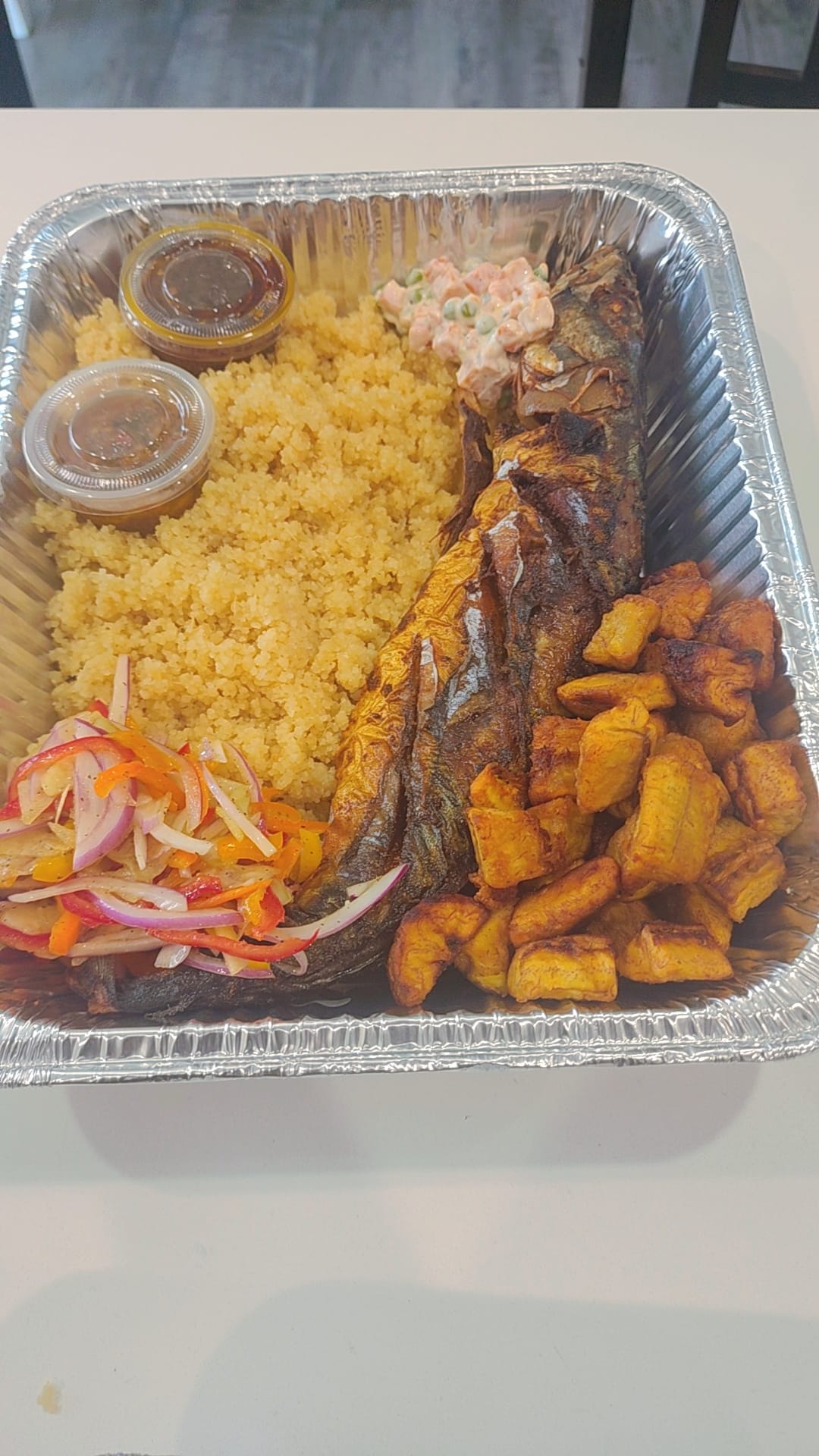 Large attieke tray with grilled fish and plantains